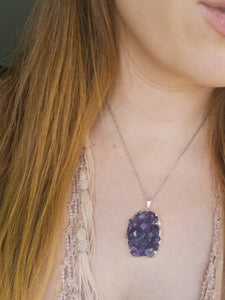 Redhead woman wears amethyst pendant necklace